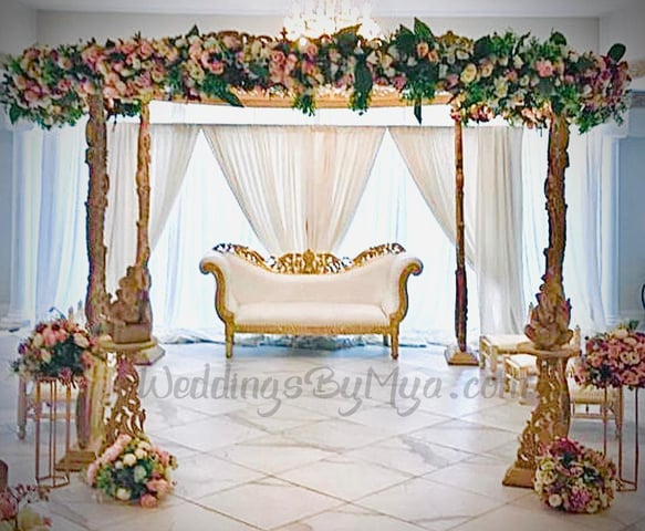 Elegant wedding mandap with floral arch and luxurious sofa for intimate ceremonies. - Banner