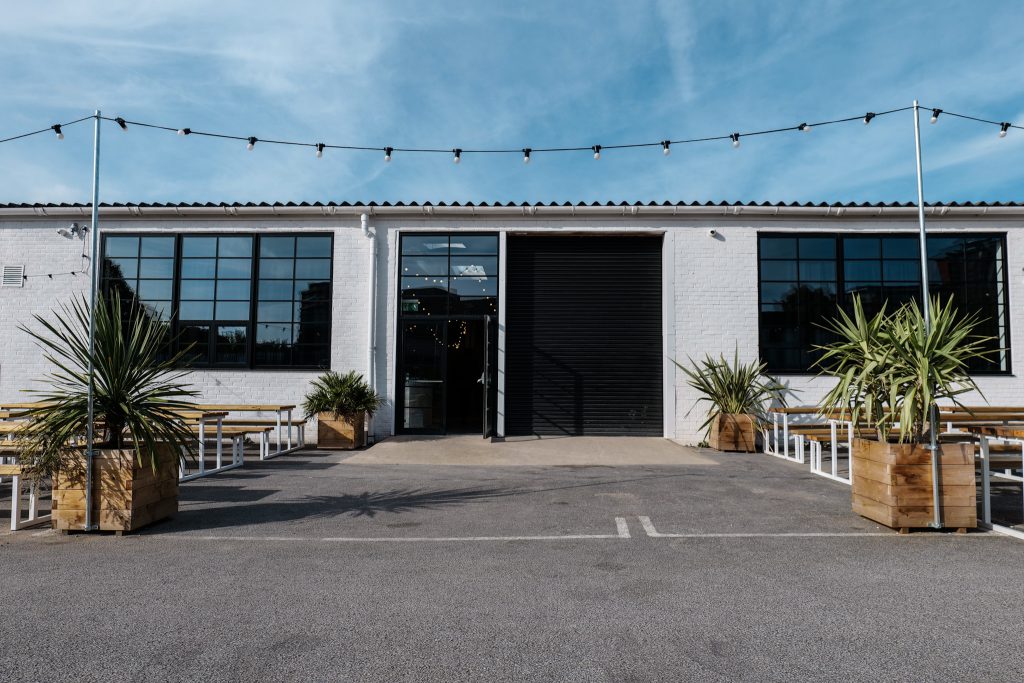 Modern event space with large windows, perfect for gatherings and networking. - Banner