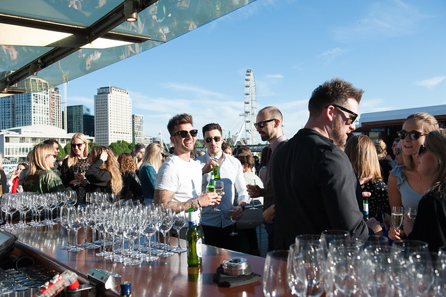 Rooftop event for 900 guests with stylish bar setup, perfect for networking and socializing. - Banner