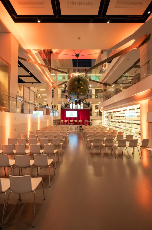 Atrium at National Army Museum: modern event space with white chairs and vibrant lighting.