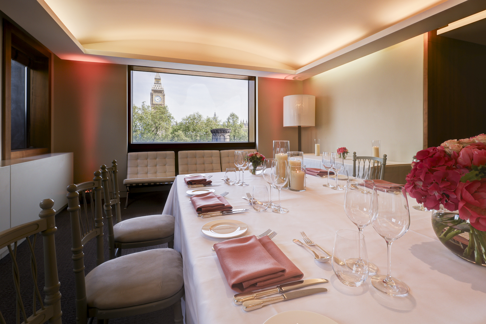 Elegant President's Dining Room set for intimate corporate event with floral centerpieces.