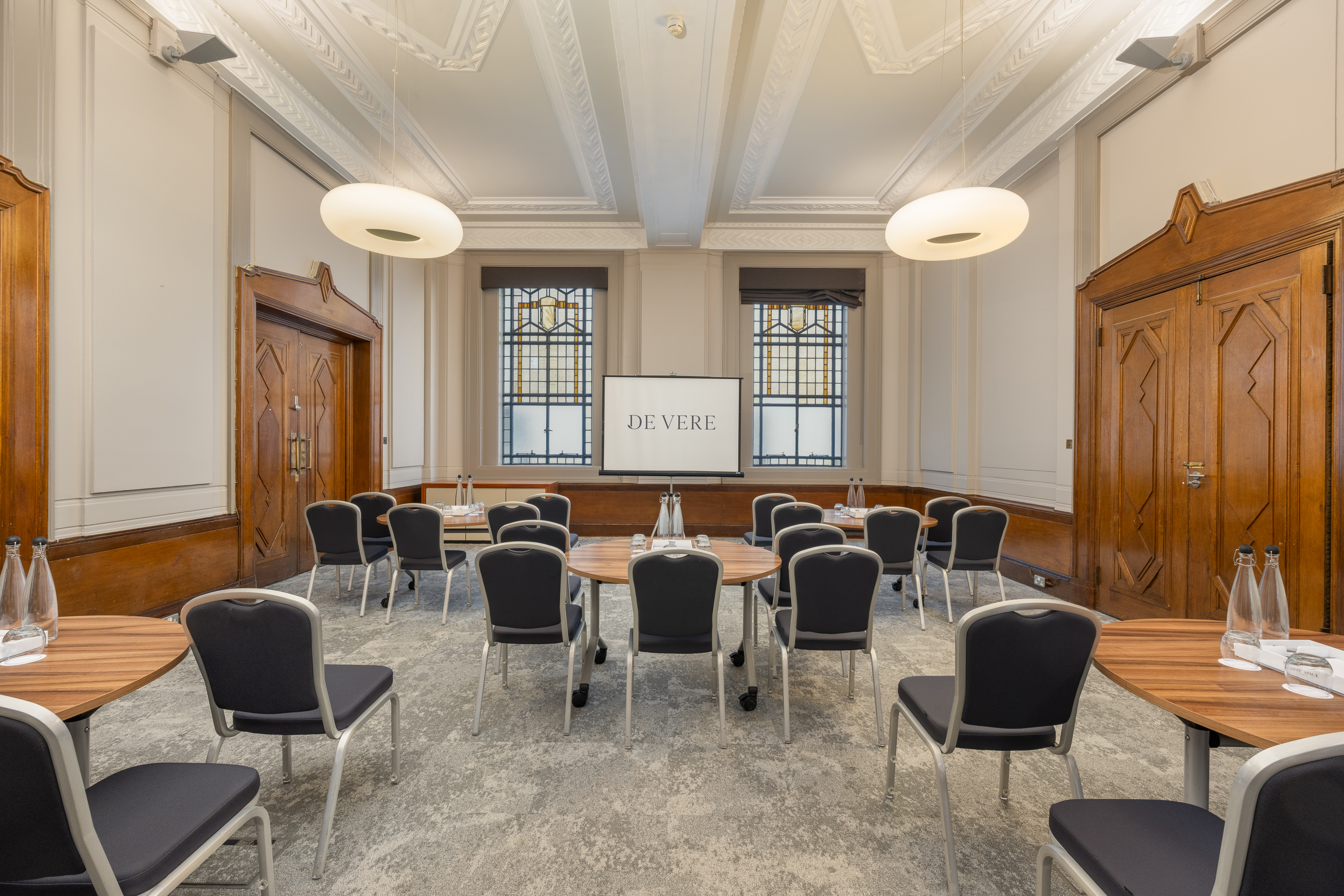 Denbigh Suite cabaret meeting room with wood paneling for corporate events and workshops.