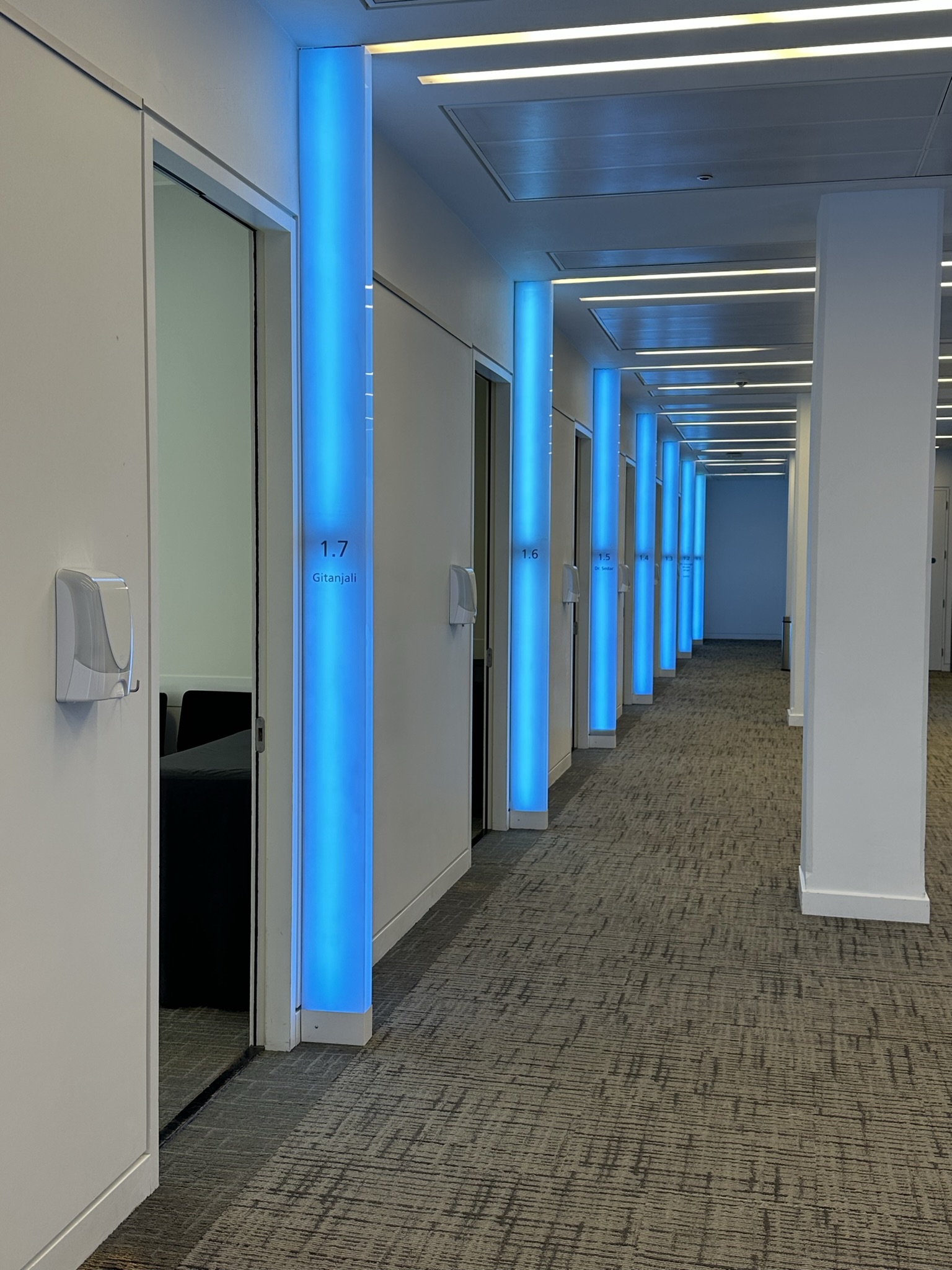 Modern corridor at Scenario Assessment Centre with blue lighting, ideal for corporate events. - Banner