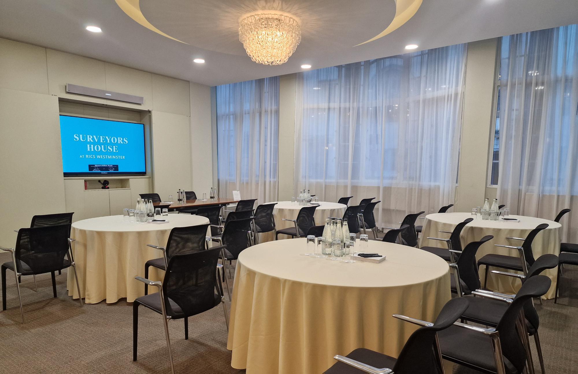 Boardroom setup with round tables at Brussels Surveyors House for professional meetings and events.