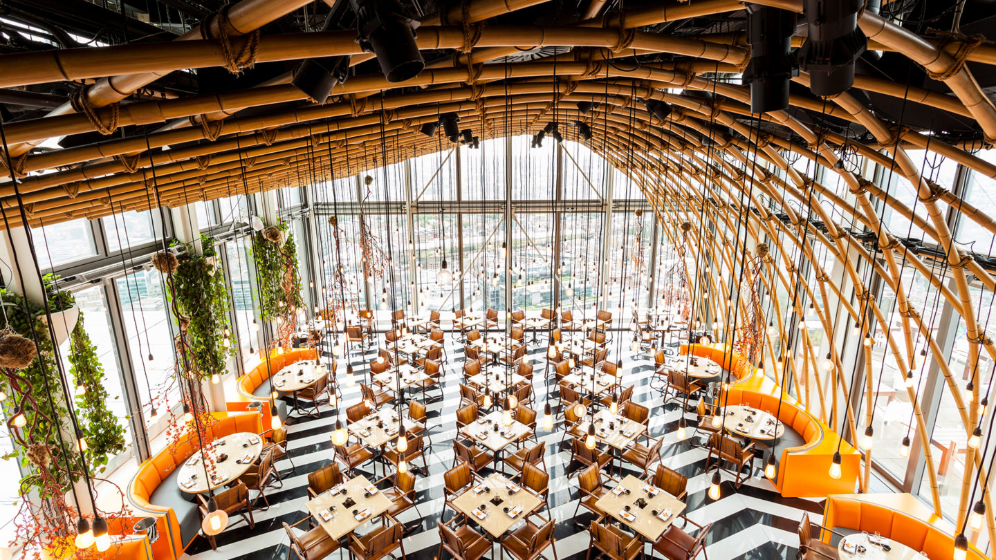 Modern restaurant interior with bamboo design, ideal for upscale events and corporate dinners.