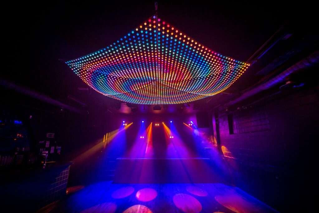 Vibrant Multiroom Event Space with LED lights for lively gatherings and dance events. - Banner