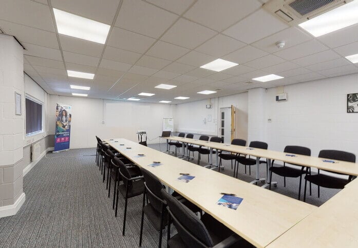 Well-lit meeting room with long table, ideal for professional gatherings and workshops.