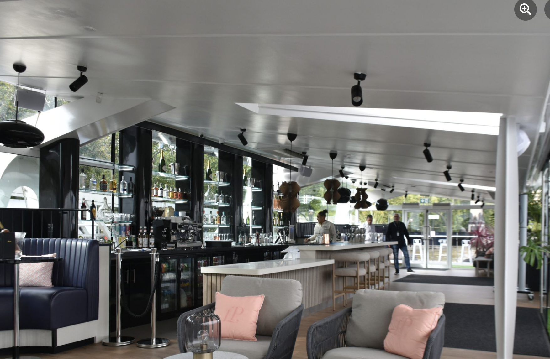 Modern Clipper Lounge EMB bar with ample seating for upscale events and gatherings. - Banner