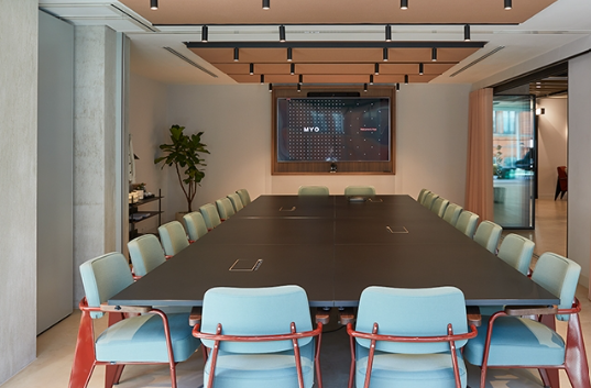 Modern conference room with sleek table, ideal for meetings and presentations. - Banner
