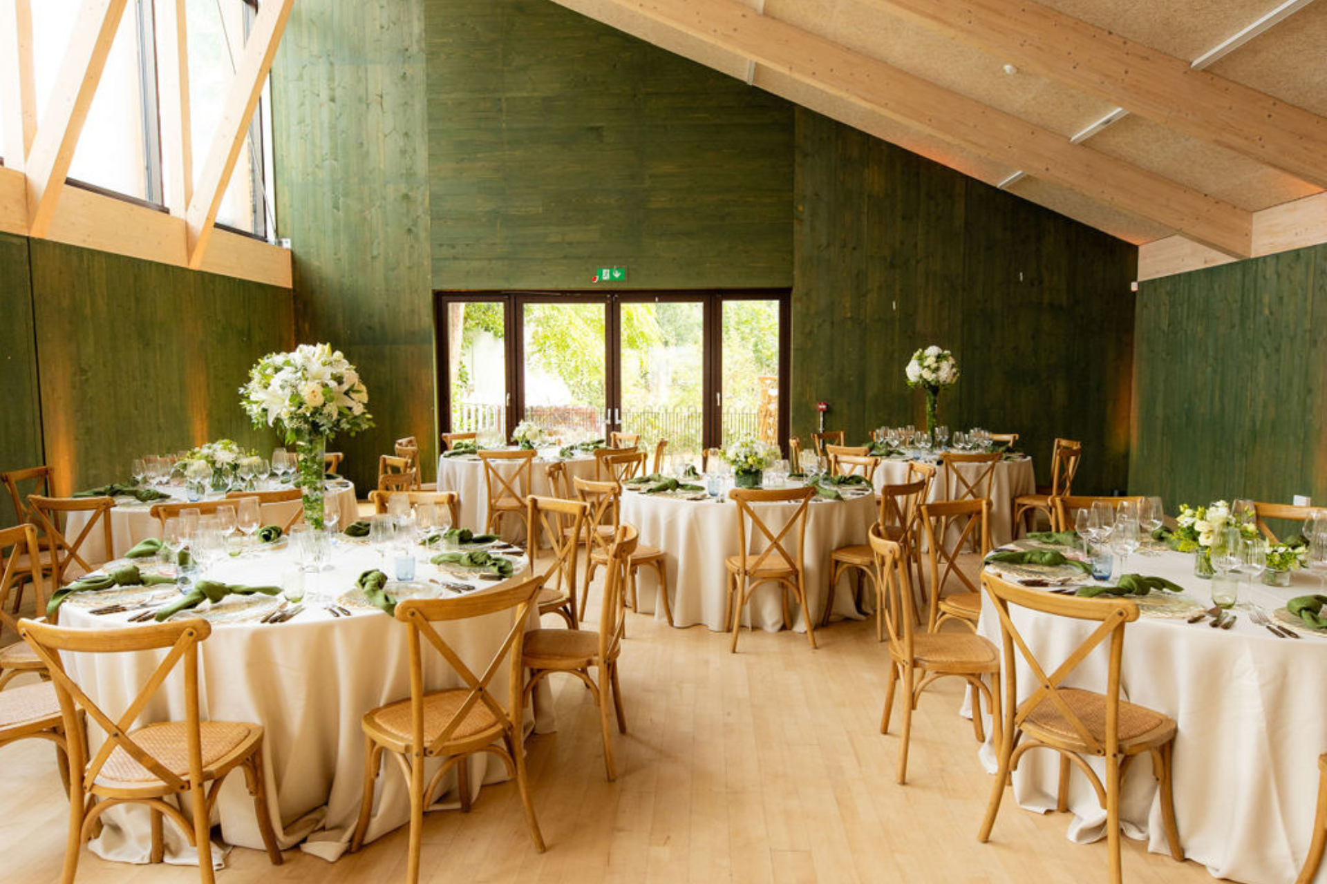 Main Hall event space with elegant round tables, ideal for weddings and upscale gatherings. - Banner