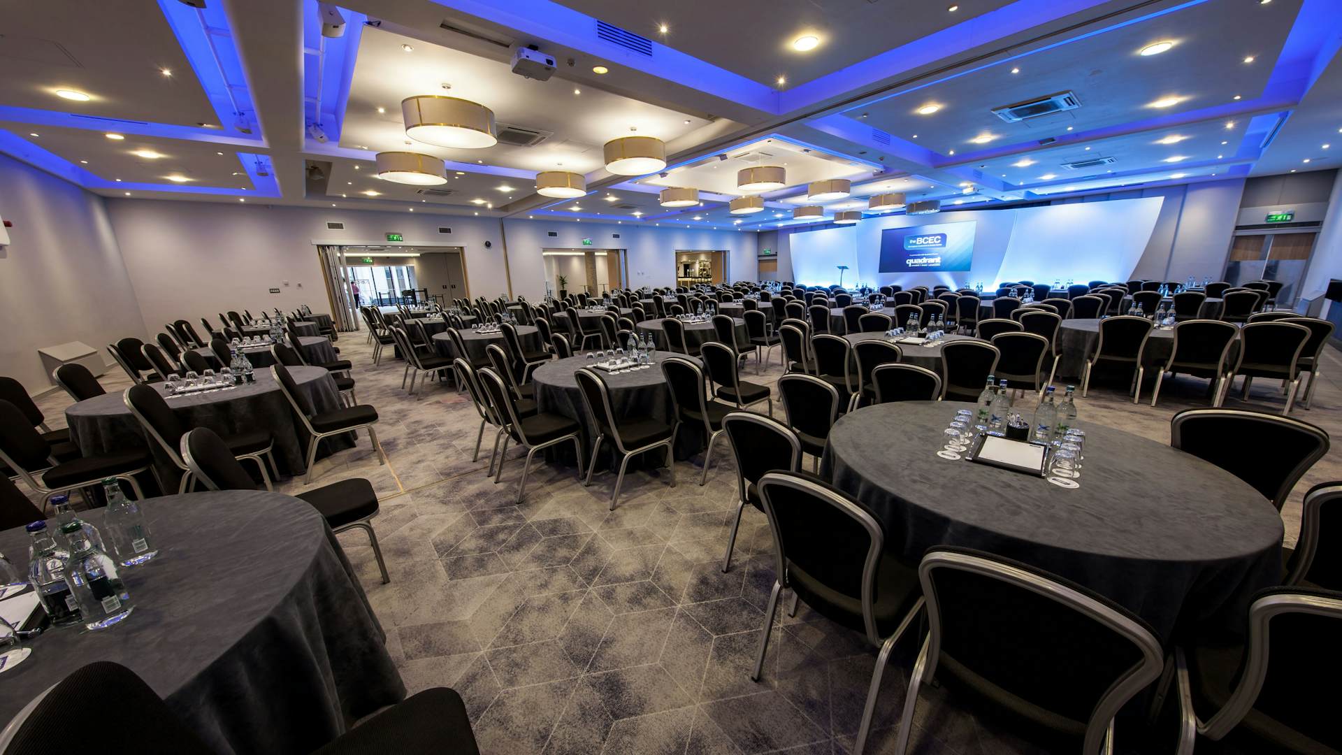 Mercian Suite at BCEC, spacious venue with round tables for corporate events. - Banner