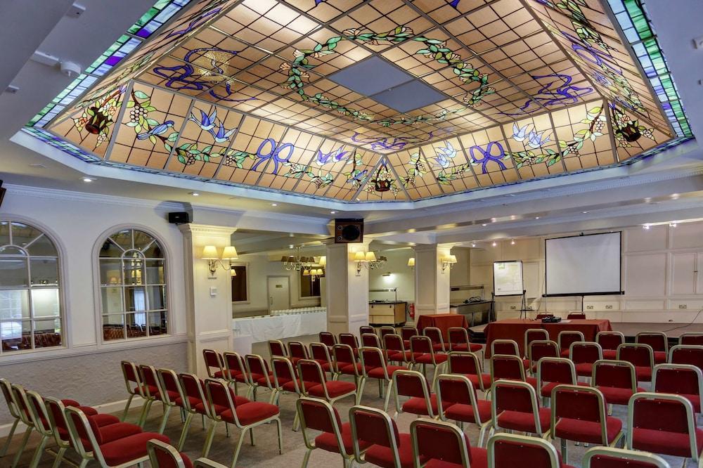Stained glass ceiling in Westley Hotel's Conservatory, perfect for conferences and seminars.