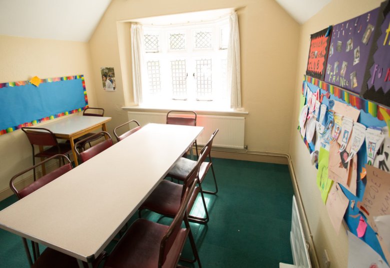 Cozy Hall Green Quaker Meeting room with long table, ideal for workshops and gatherings.