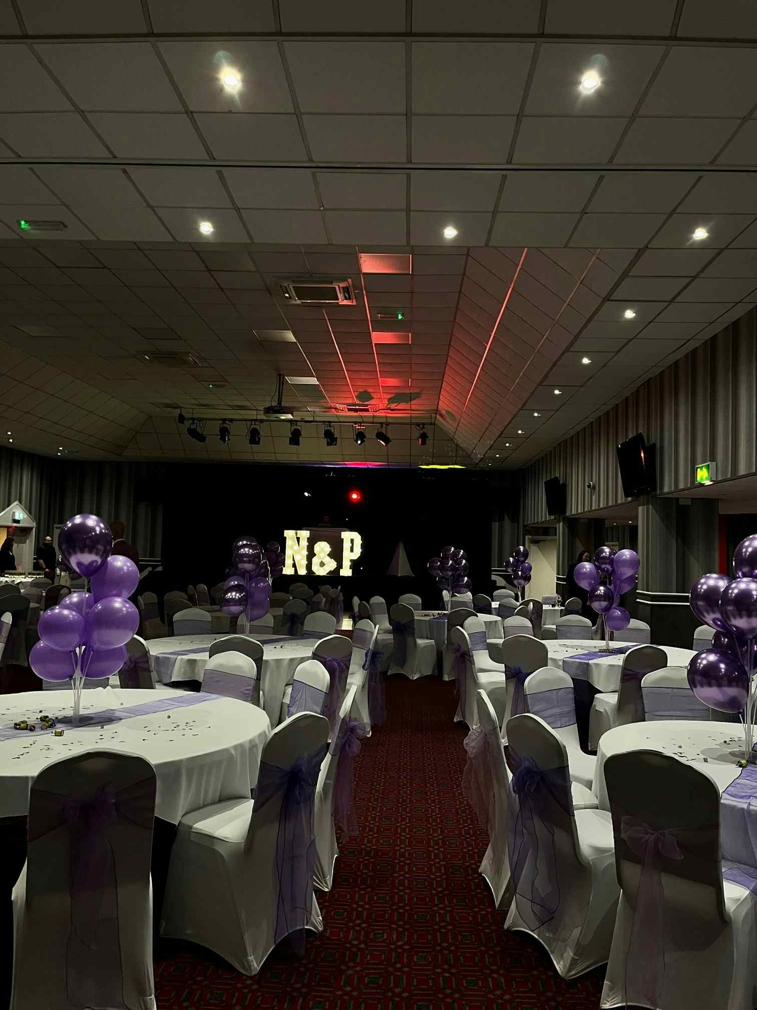 Elegant event space with purple balloons, ideal for celebrations and corporate gatherings.
