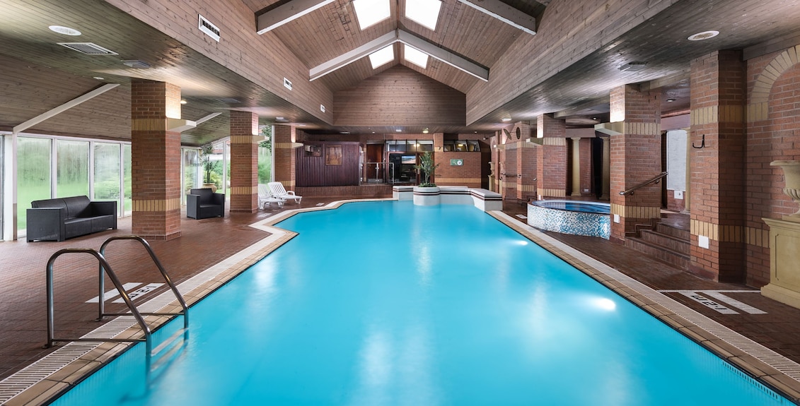 Spacious indoor pool at voco St. John's Solihull for events and wellness retreats.