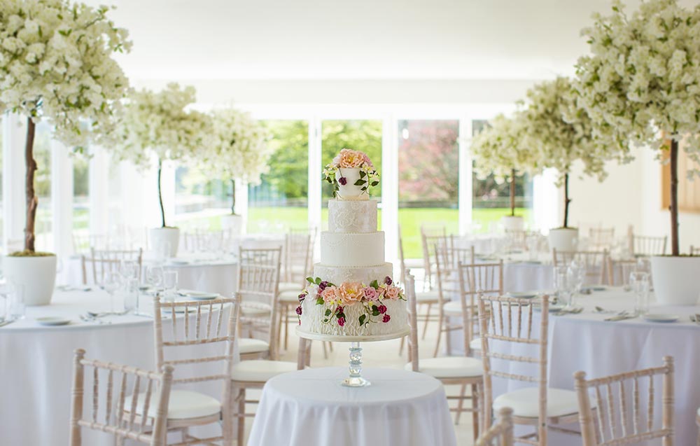 De Port Private Dining Room with elegant tables and floral centerpieces for wedding receptions. - Banner