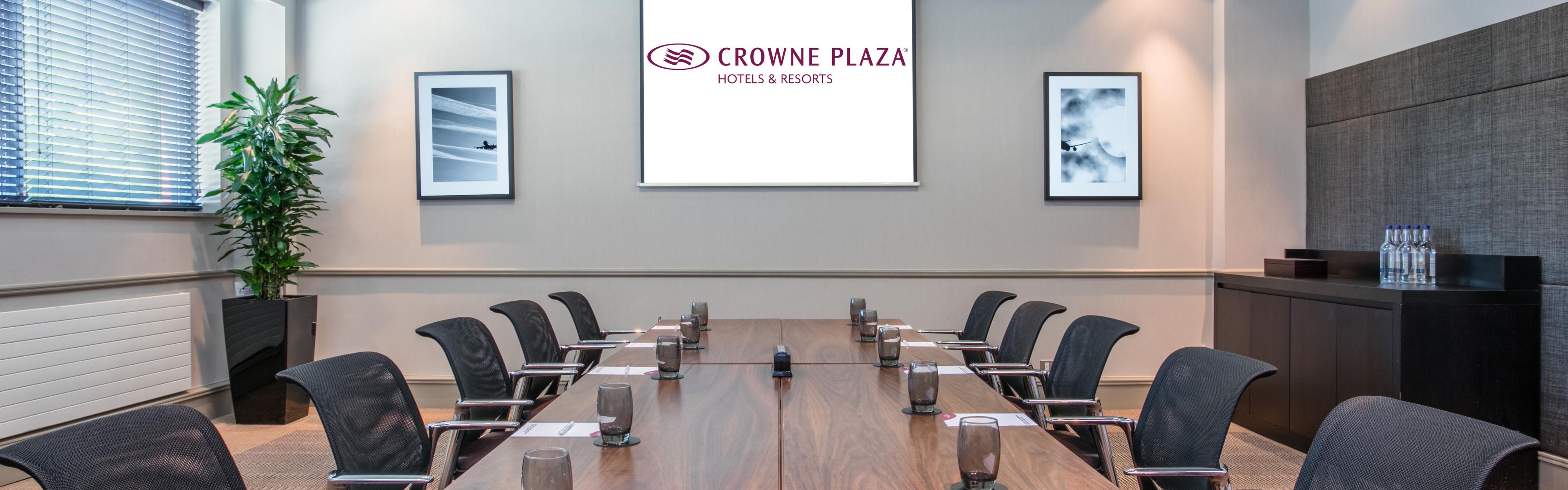 Oasis Suite meeting room at Crowne Plaza Birmingham NEC, featuring a large wooden table.