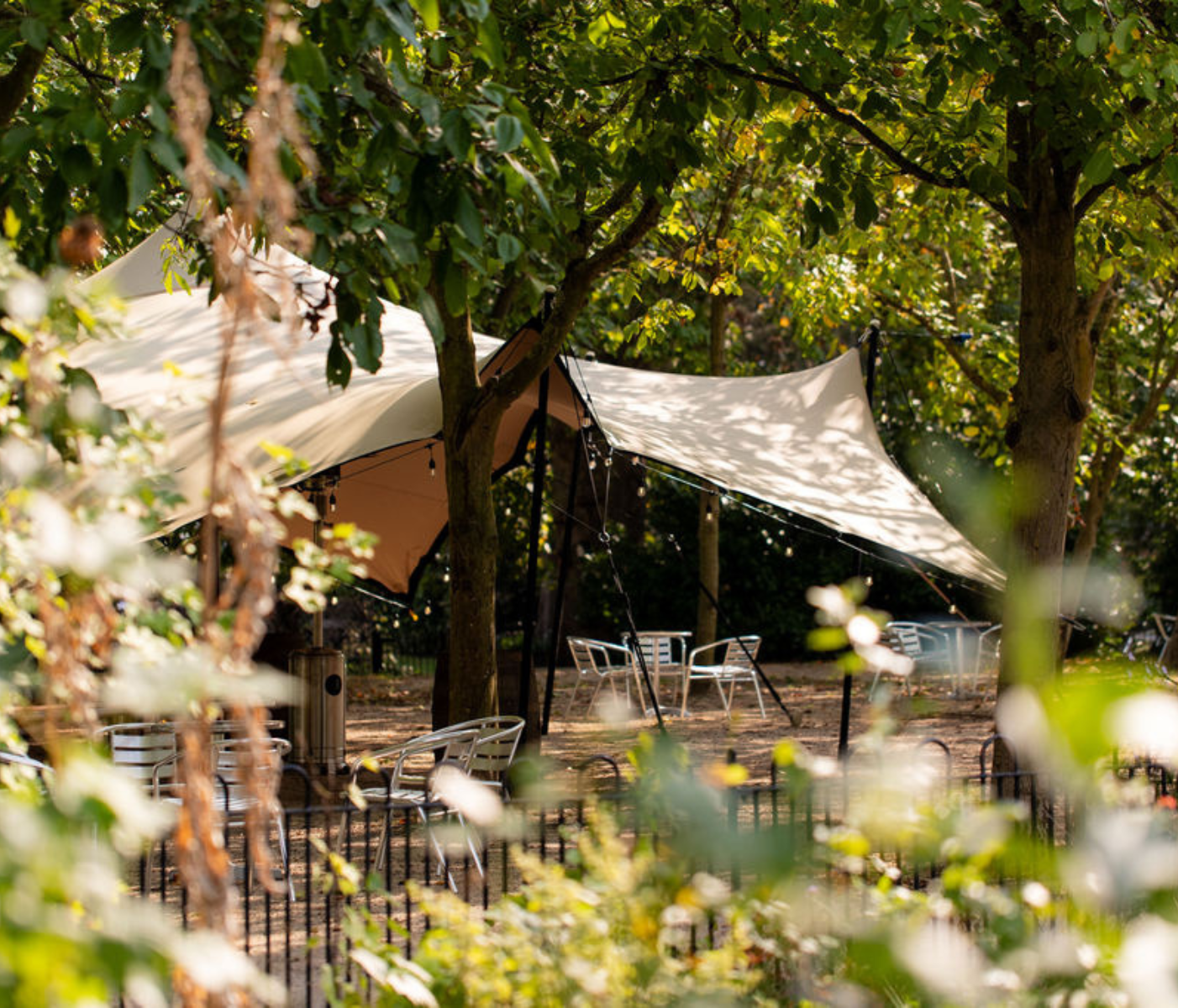 Outdoor event space with large tent, ideal for corporate retreats and gatherings. - Banner