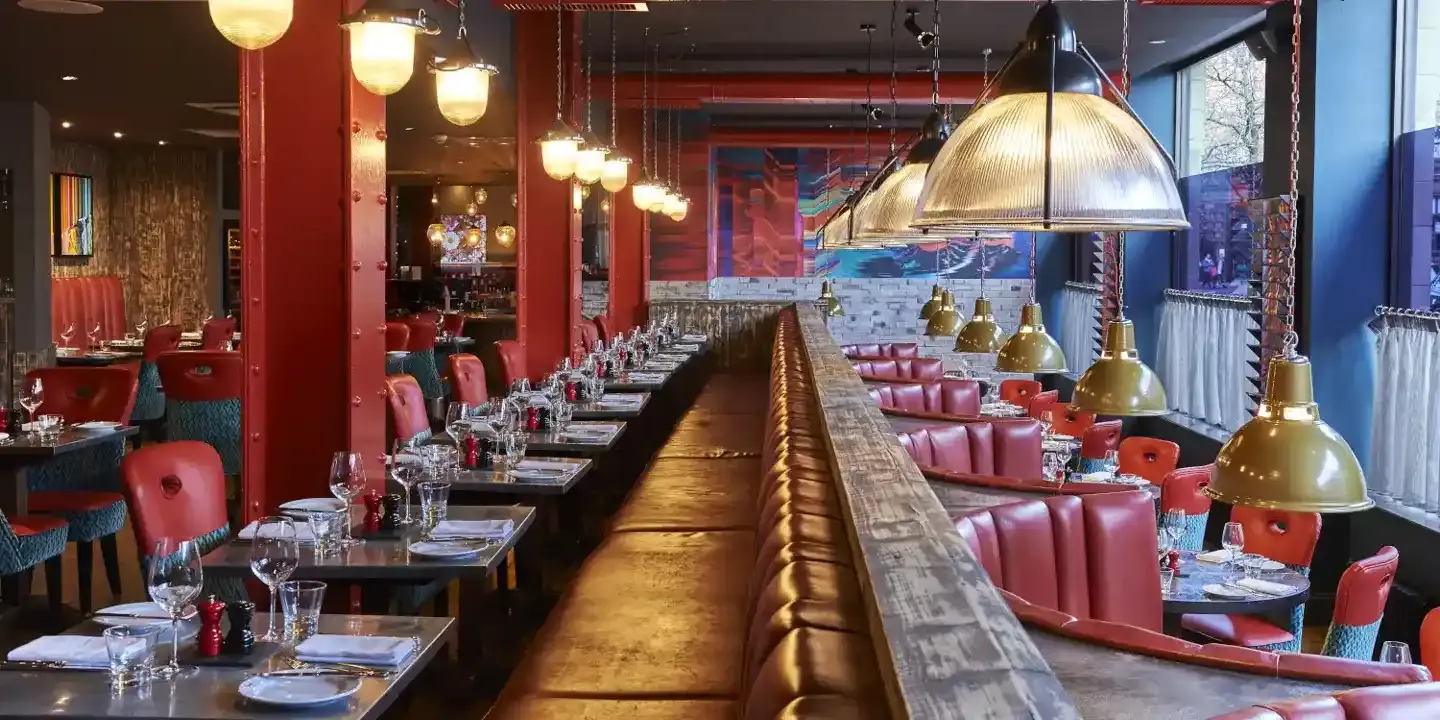 Vibrant Bistro in Malmaison Manchester with communal table for events and gatherings.