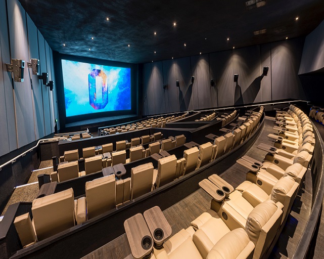 Modern cinema auditorium with plush seating and large screen in ODEON LUXE Birmingham.