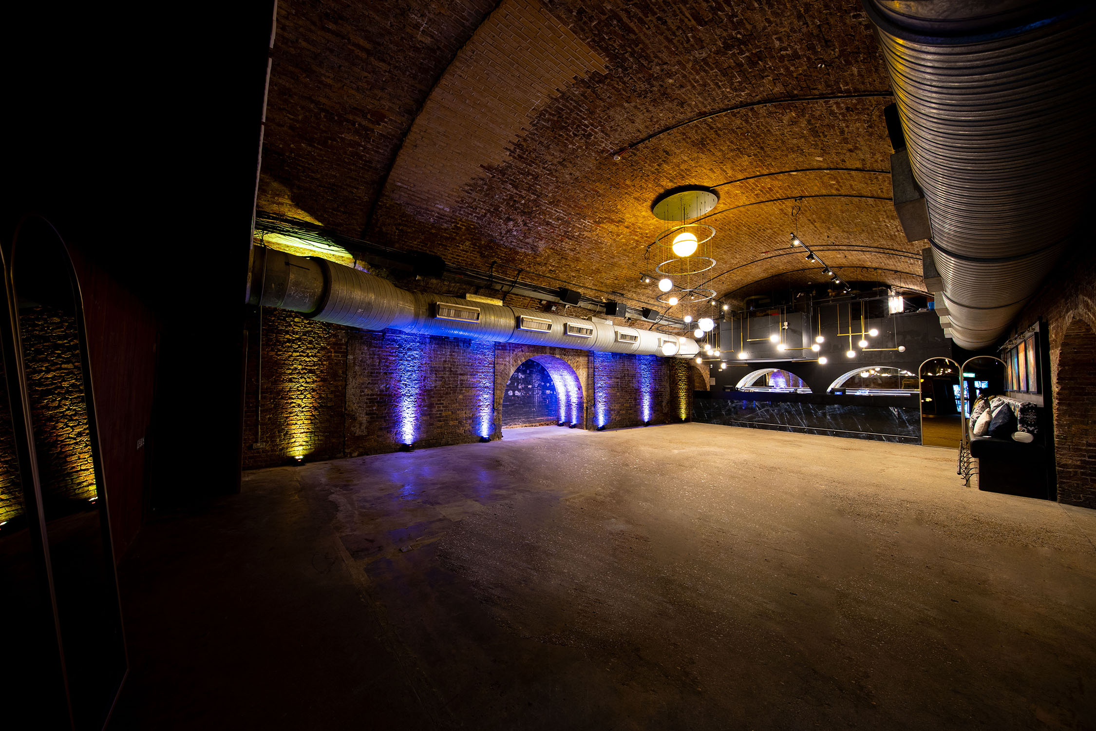 Versatile event space with exposed brick walls, ideal for conferences and receptions. - Banner
