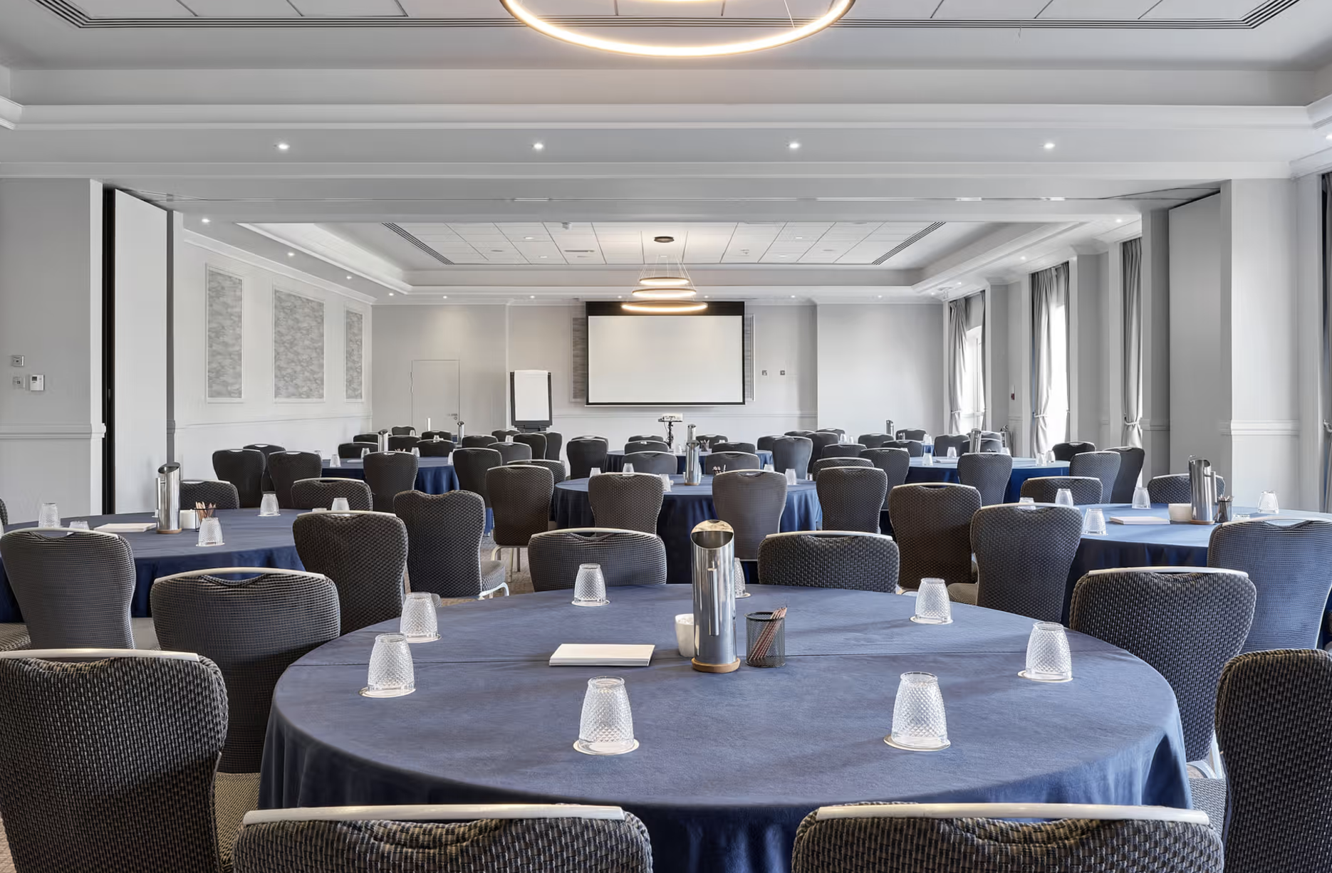 Thorpe Suite meeting room with navy tables, perfect for corporate events and presentations. - Banner