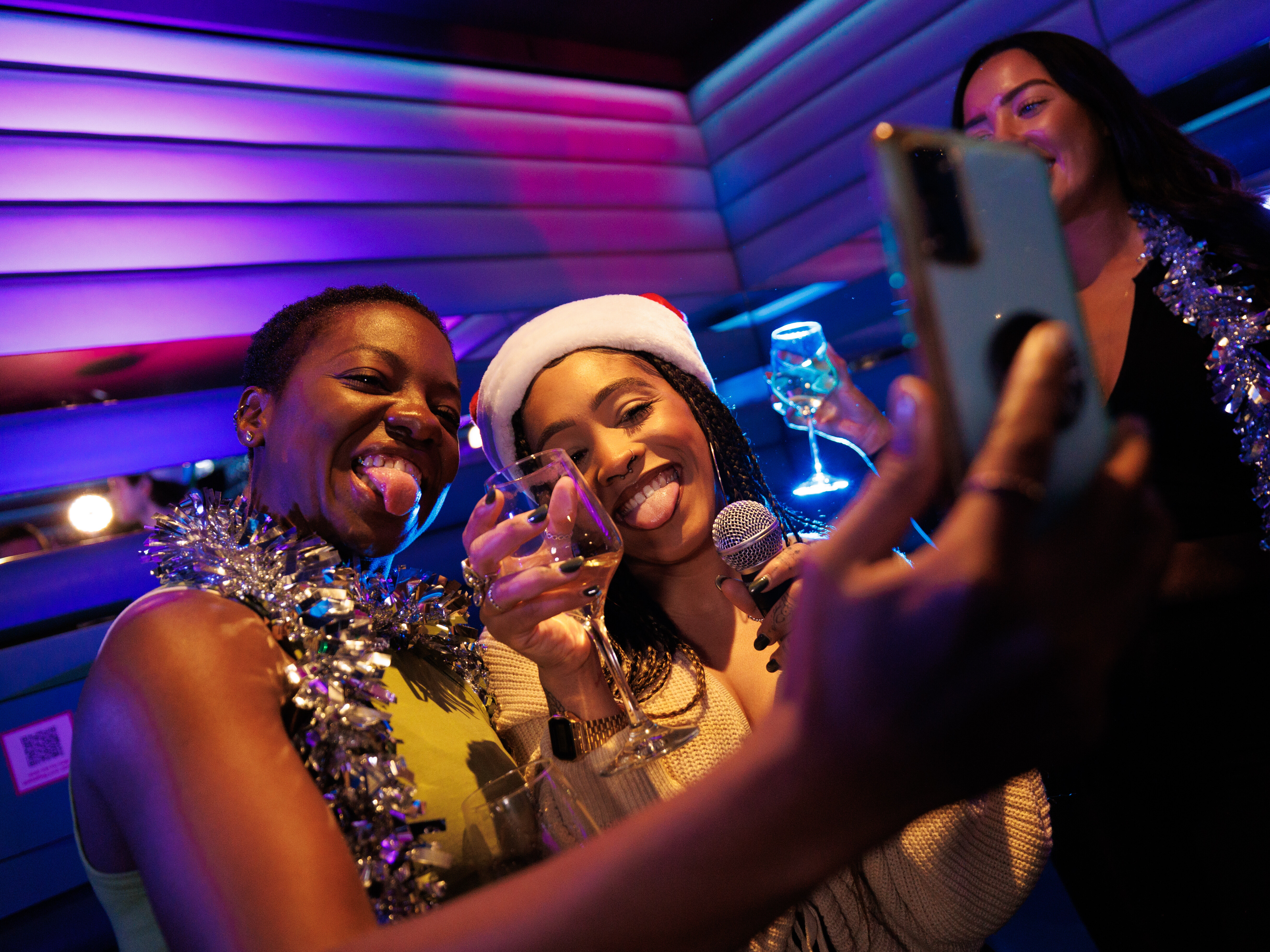 Christmas party at Lucky Voice Holborn with vibrant lighting and festive atmosphere.