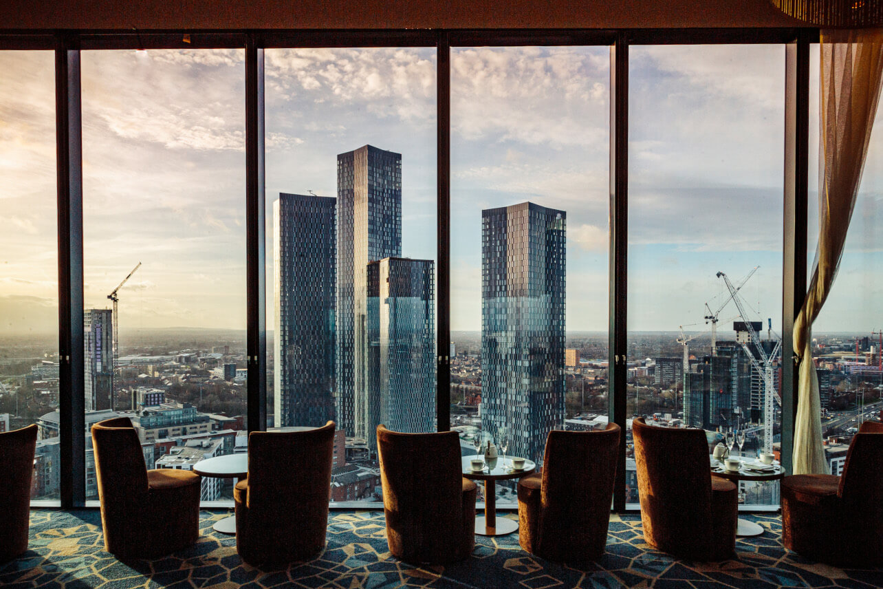 Upscale venue with panoramic city skyline, perfect for corporate meetings and events.