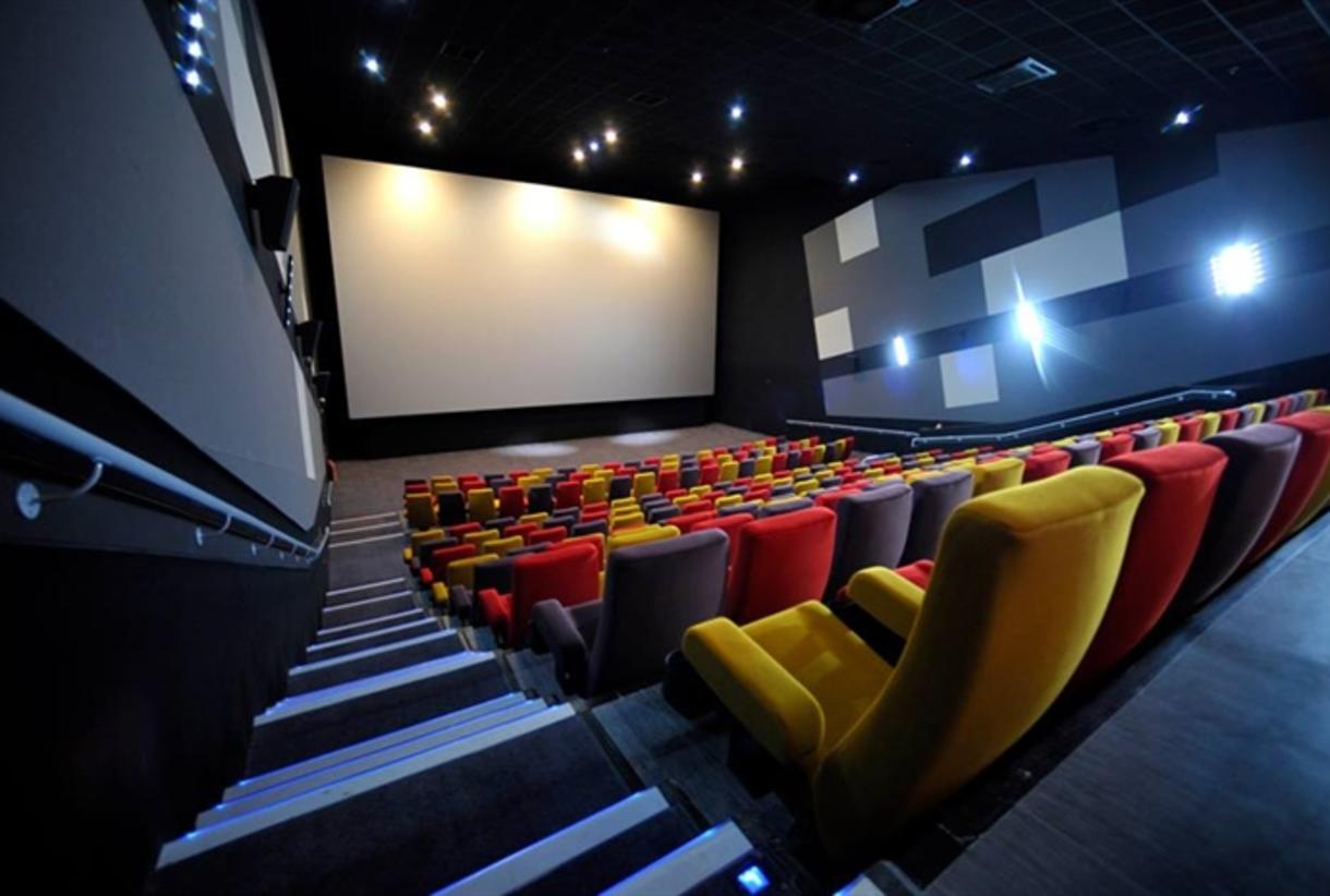 Modern cinema auditorium with tiered seating, perfect for film premieres and corporate events. - Banner