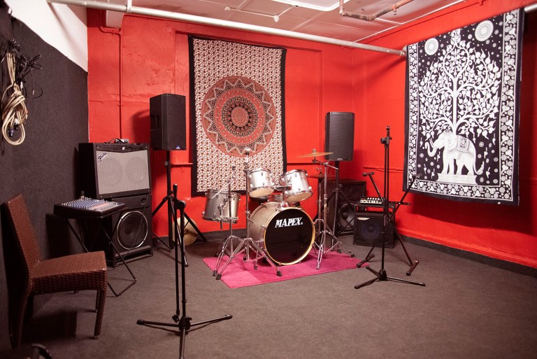 Vibrant Elm Studios rehearsal space with audio equipment for creative gatherings. - Banner