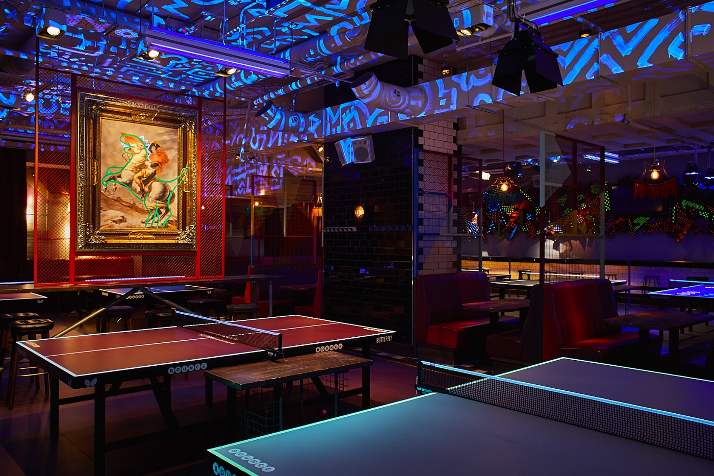 Vibrant event space with ping pong tables for networking and team-building activities.