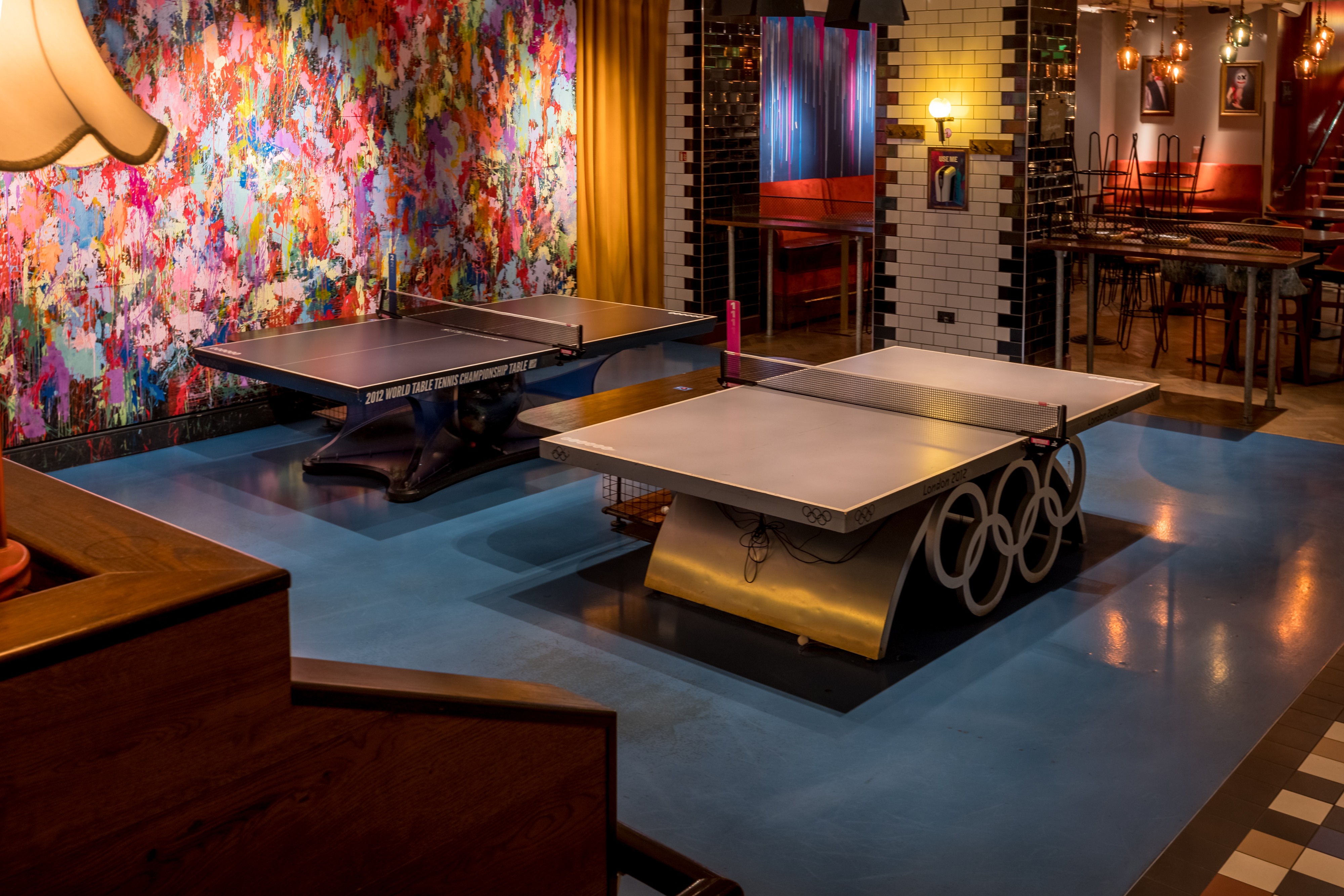 Vibrant event space with stylish ping pong tables for networking and team-building.