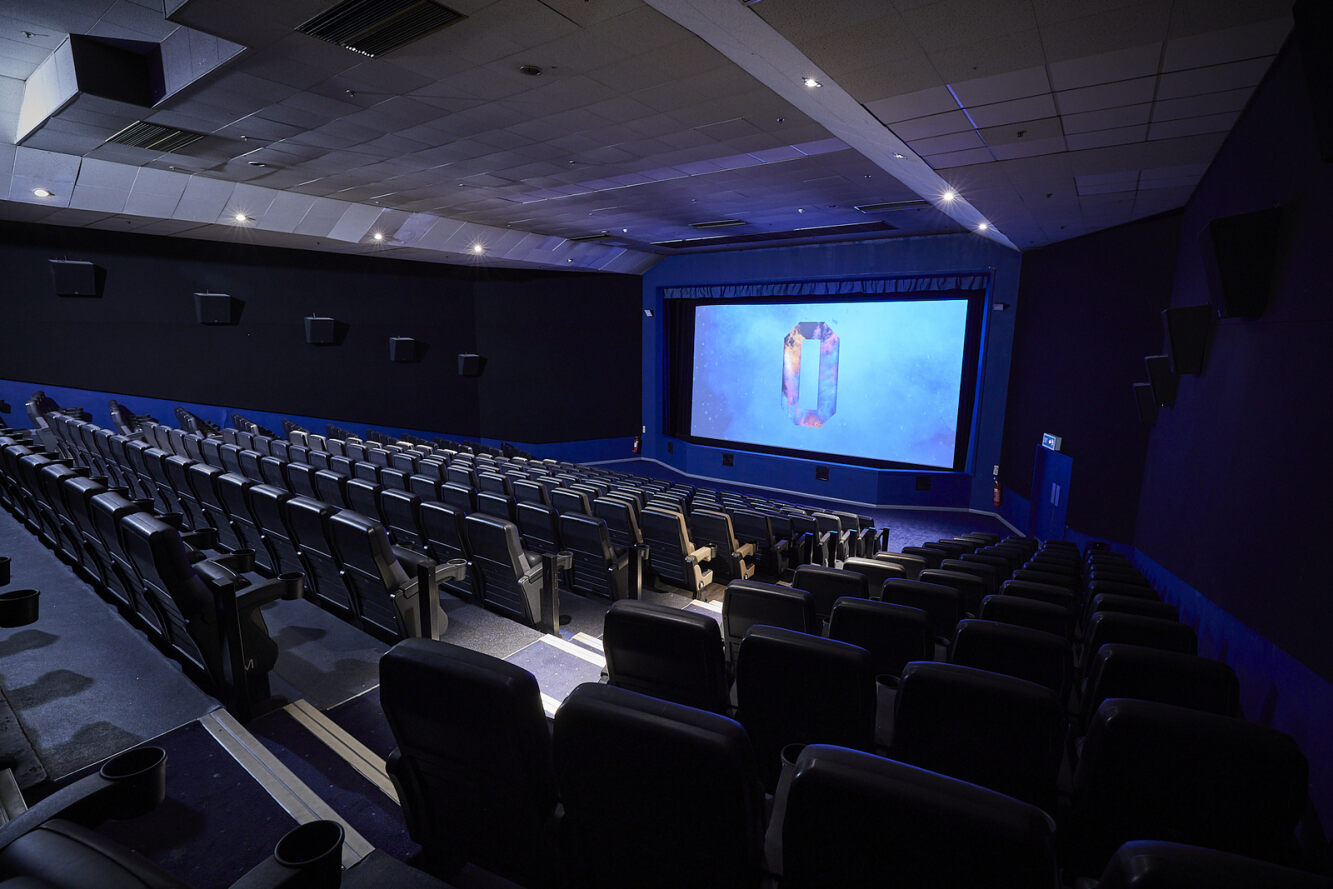 Spacious ODEON cinema auditorium with tiered seating for film screenings and events.