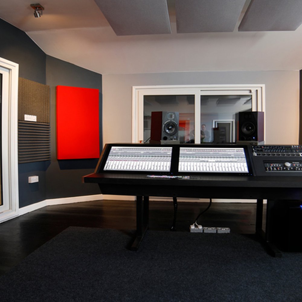 Professional audio recording studio with dual control panels for events and meetings.