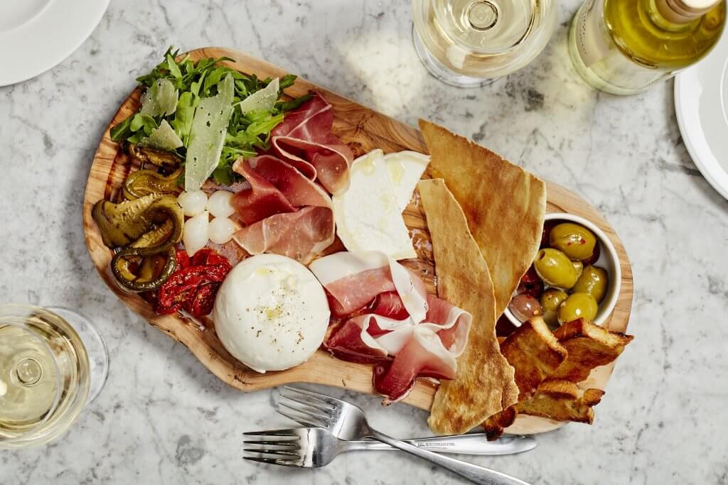 Charcuterie board at Gusto Italian, perfect for networking events and upscale gatherings.