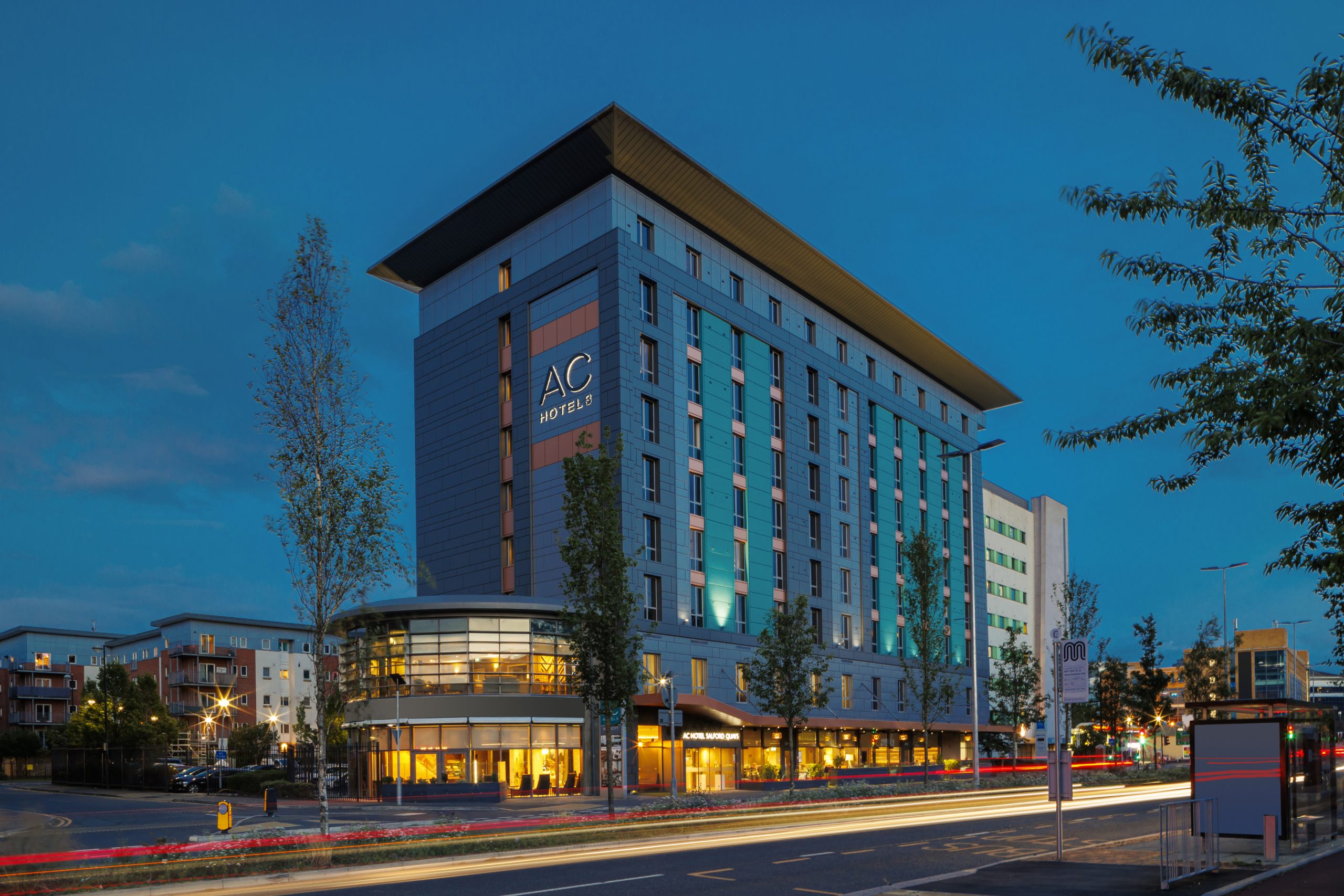 Modern AC Hotel Manchester Salford Quays exterior, ideal for corporate events and meetings. - Banner