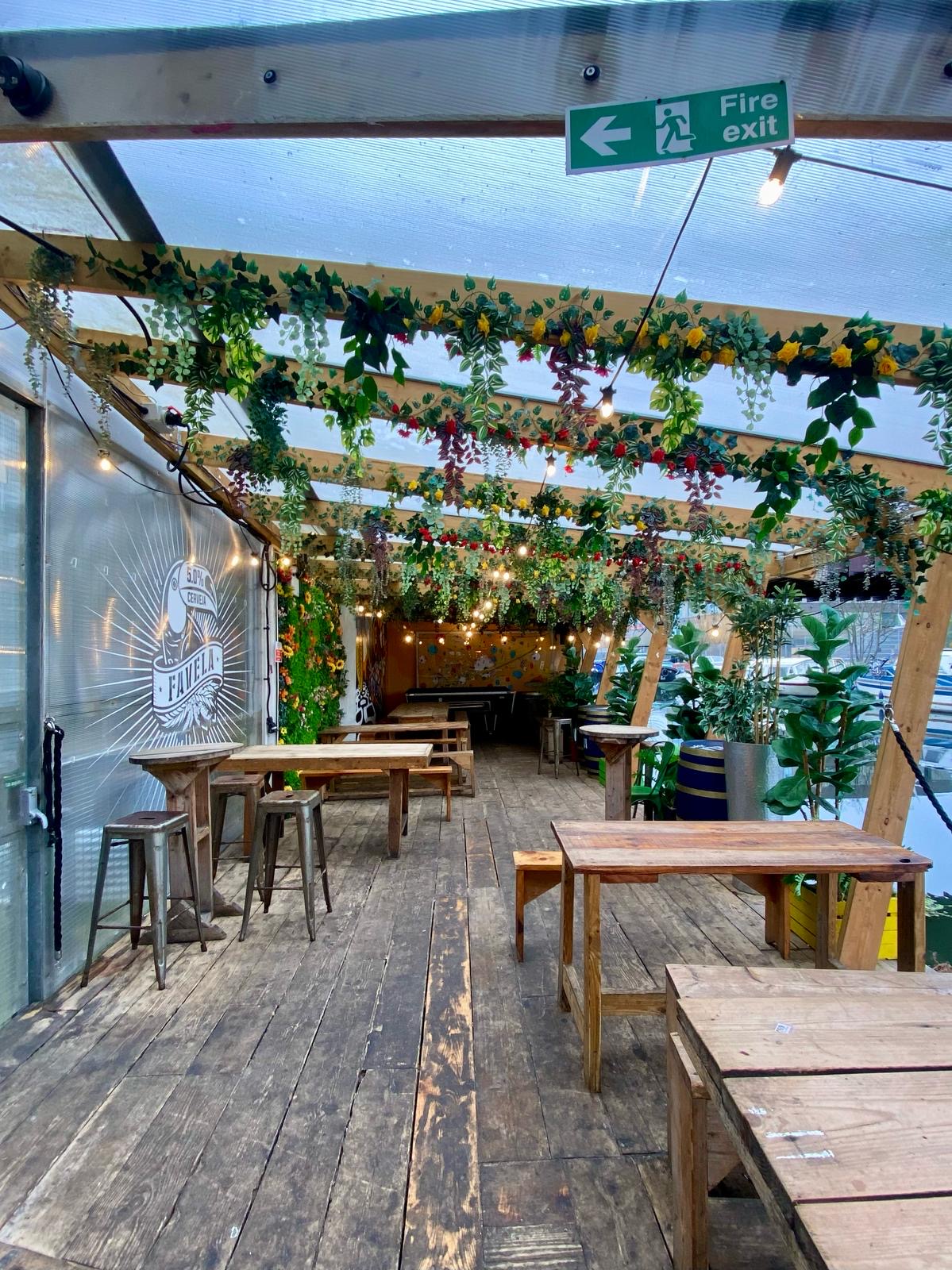 AstroDeck Terrace in Hackney Wick, decorated outdoor event space with lush greenery. - Banner