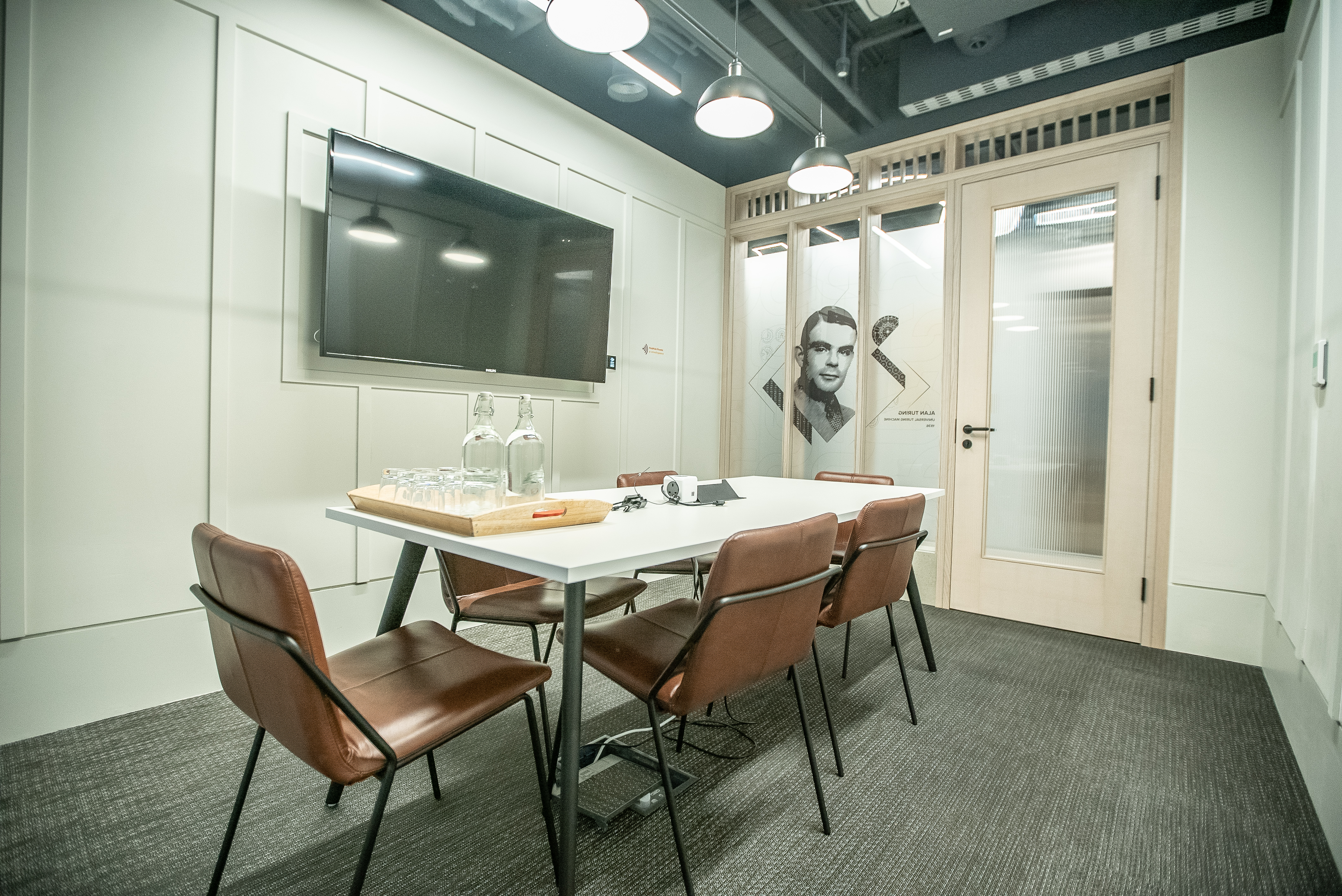 Modern meeting room at HubHub Farringdon with sleek table and glass doors for collaboration. - Banner