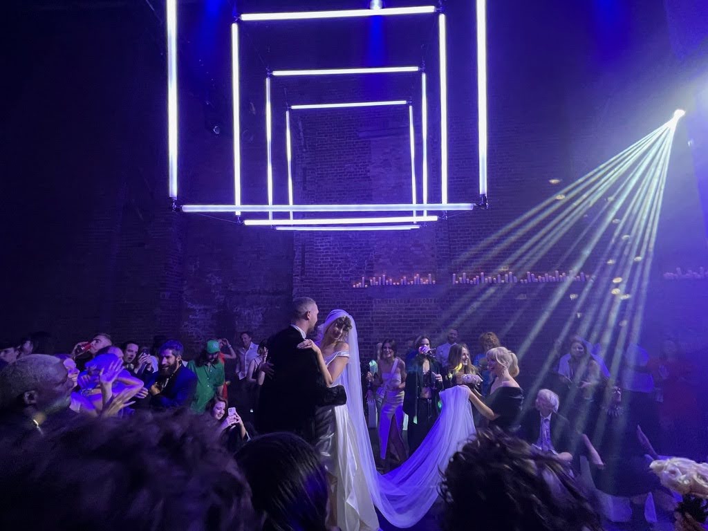 Wedding reception couple dancing under geometric lights at Village Underground.