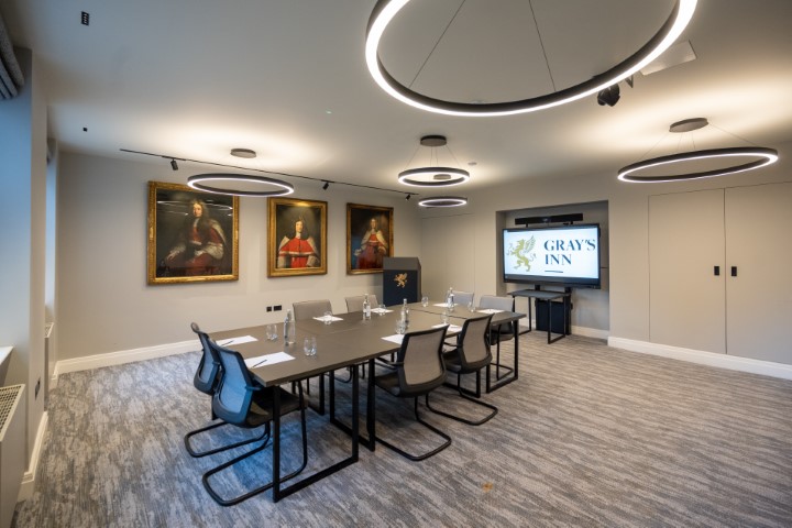 Modern meeting room at The Holt, Gray's Inn, with ergonomic chairs and presentation screen.