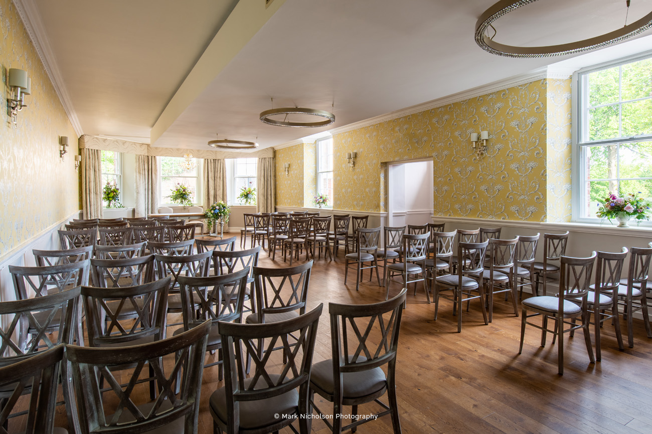 The River Room in Old Palace Chester: elegant event space with wooden chairs for gatherings.