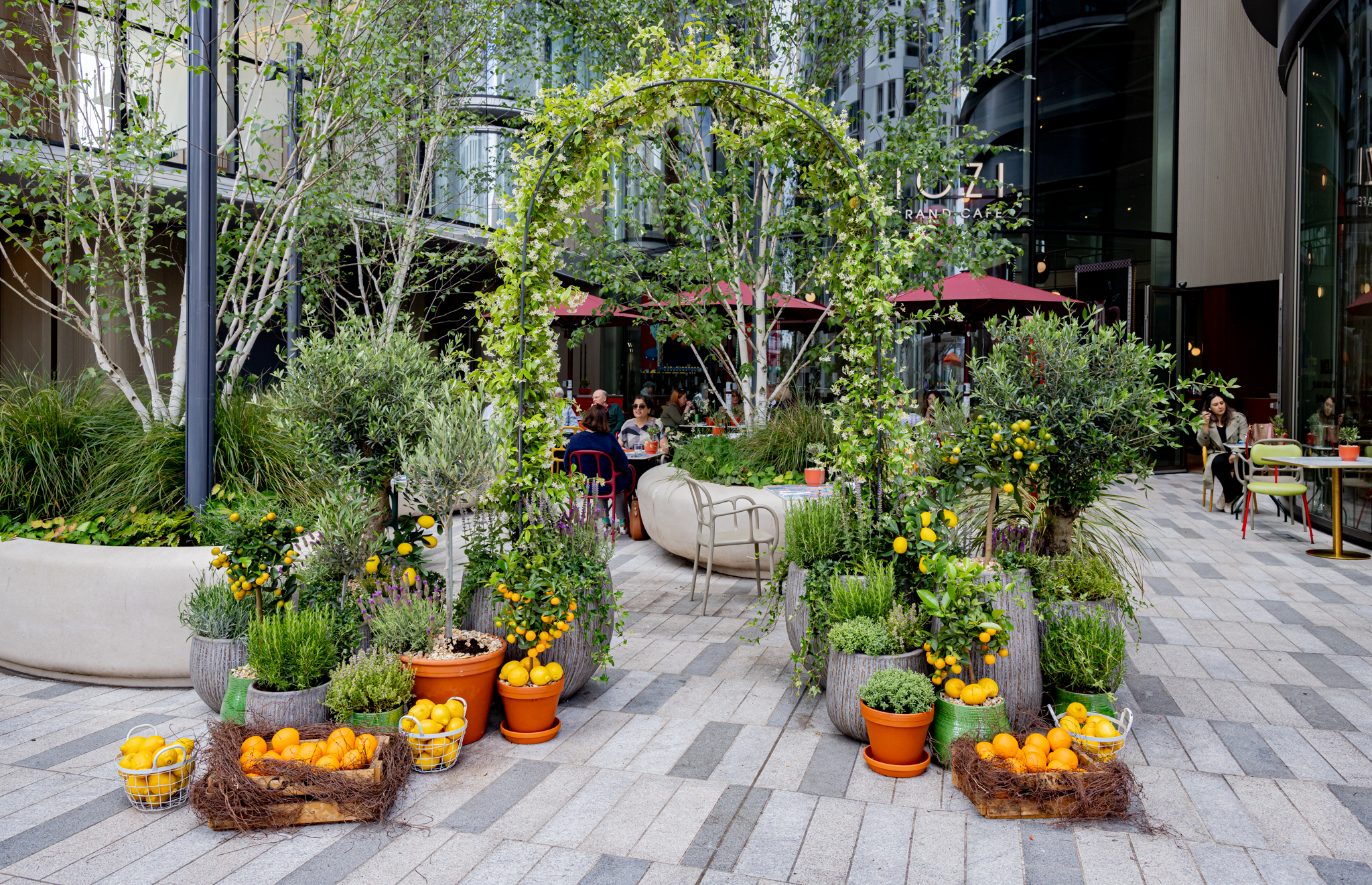 Tozi Terrace at art'otel London: vibrant outdoor event space with lush greenery.