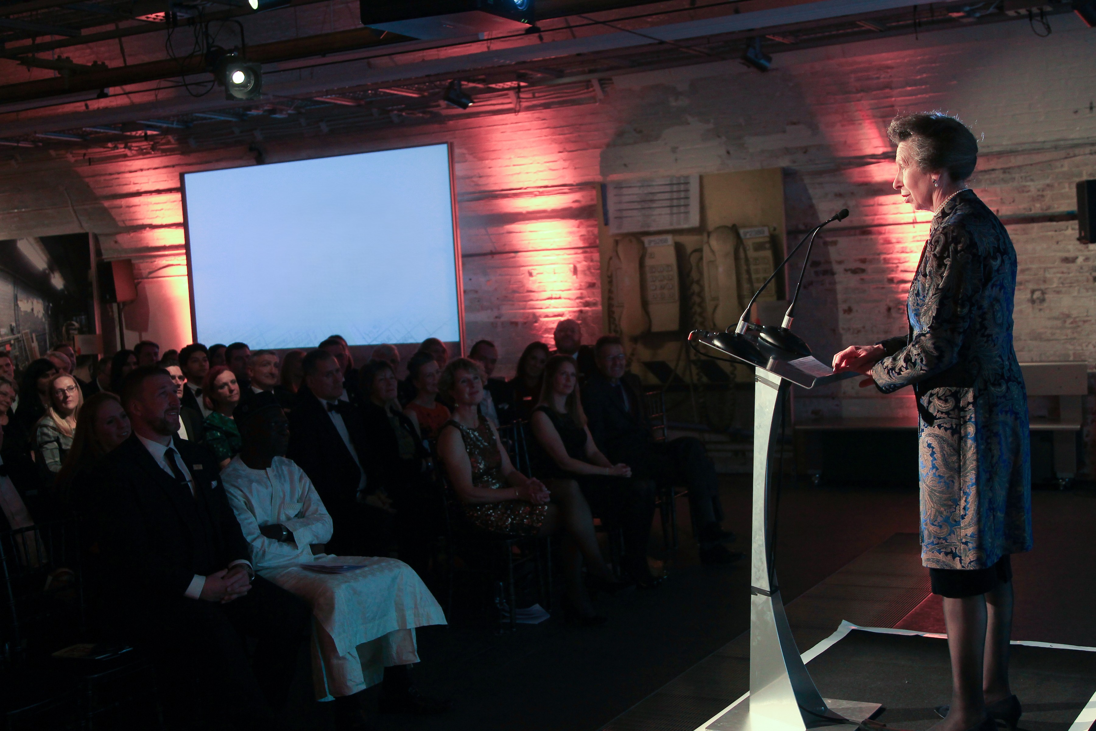 Conference speaker engaging audience at The Postal Museum with multimedia setup.