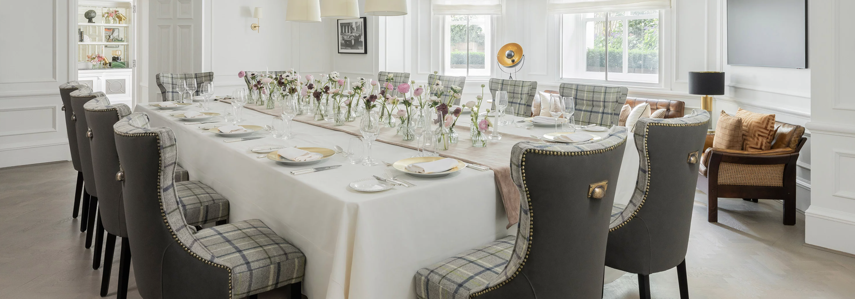 Elegant dining table with floral centerpieces for corporate dinner at The Langham, London.