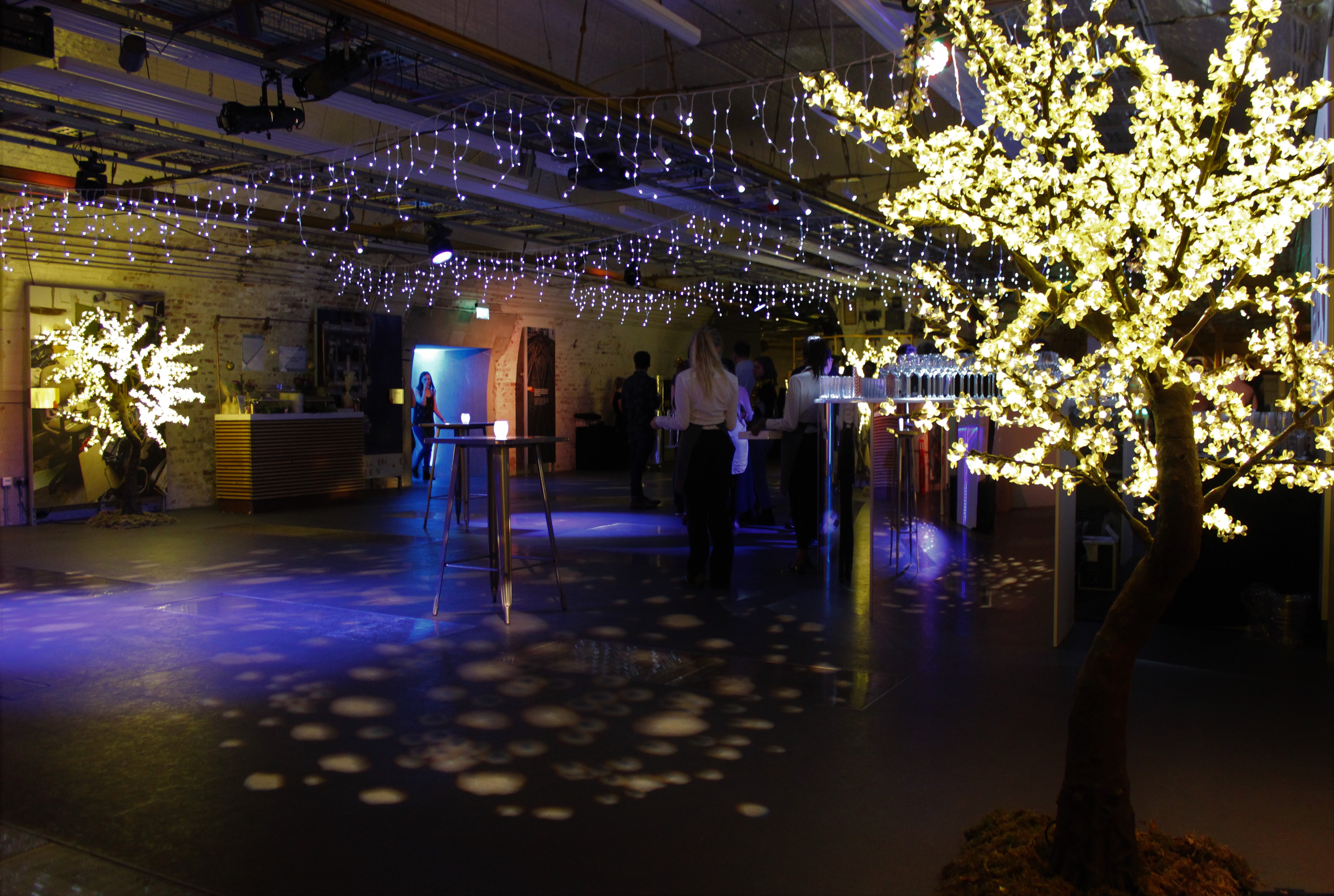 Enchanting event space with fairy lights at The Postal Museum for networking and celebrations.