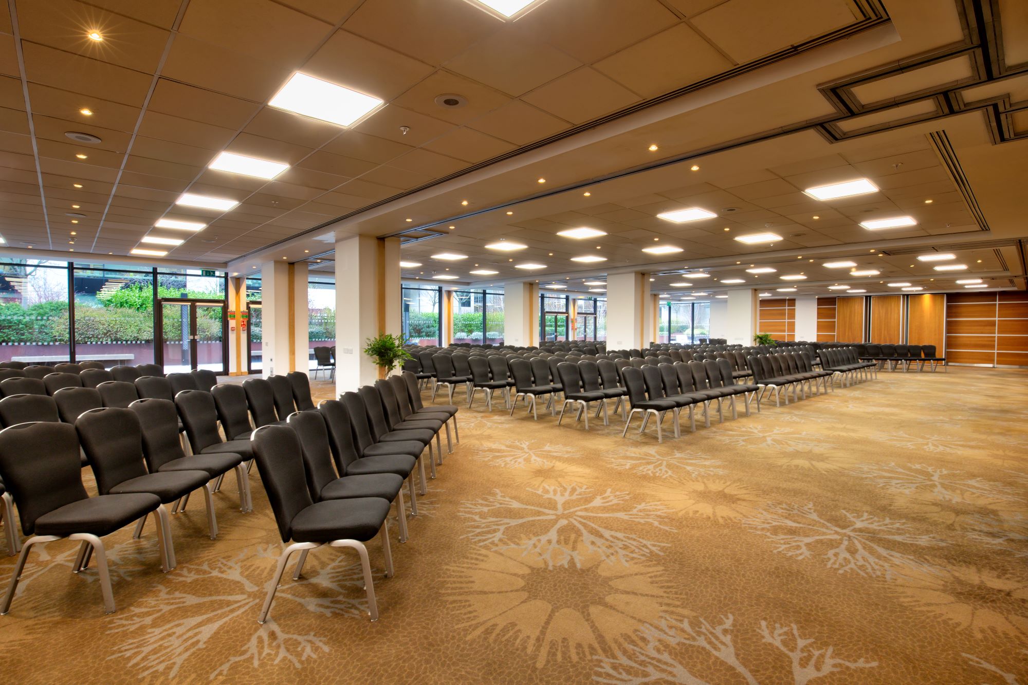 Reims venue in Novotel London West with black chairs for conferences and meetings.