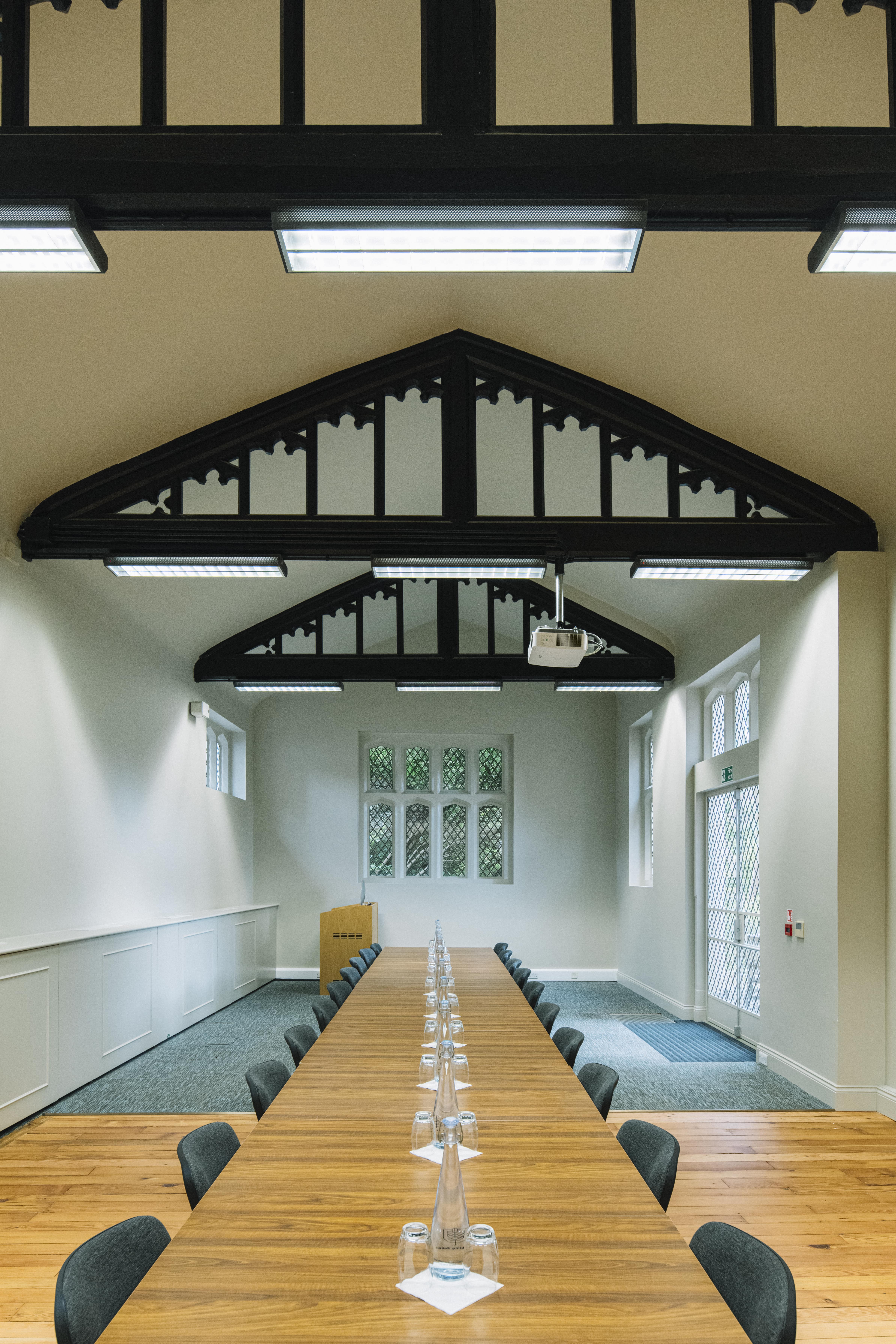 Red Lodge meeting space at Ashridge House, featuring a high ceiling for events and presentations.
