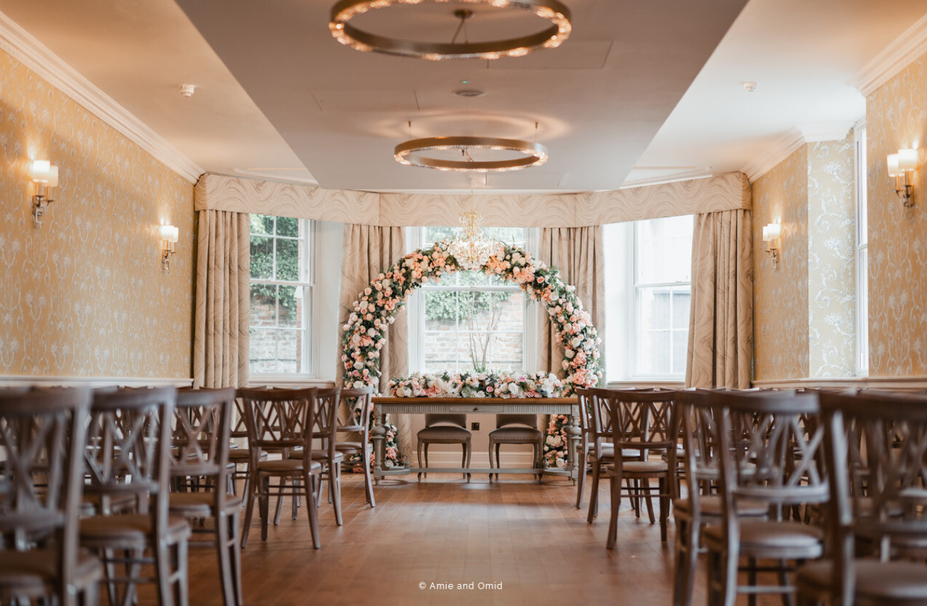 Elegant wedding setup with floral arch at Old Palace Chester, ideal for intimate ceremonies.
