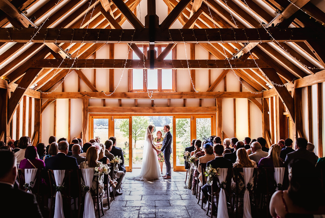 Wedding ceremony at Brookfield Barn with elegant floral arrangements and natural light.