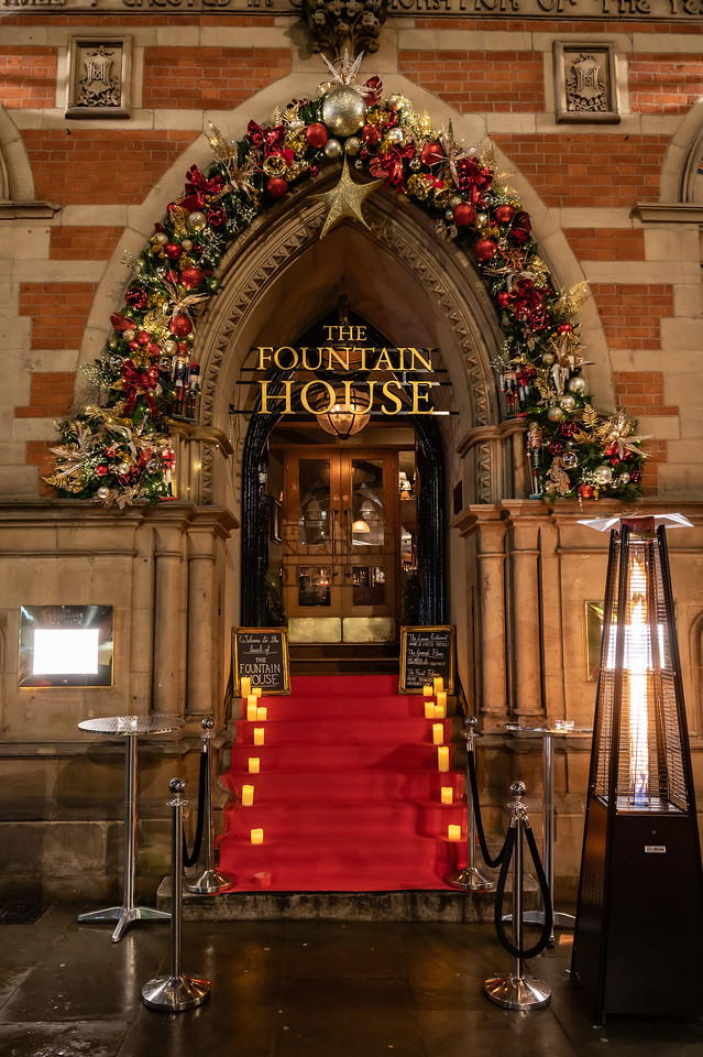 Elegant bar entrance at The Fountain House with floral decor for upscale events.